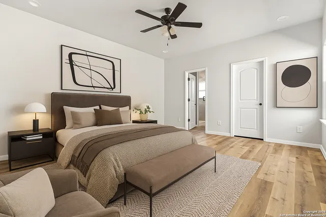 a bedroom with a bed and painting on the wall