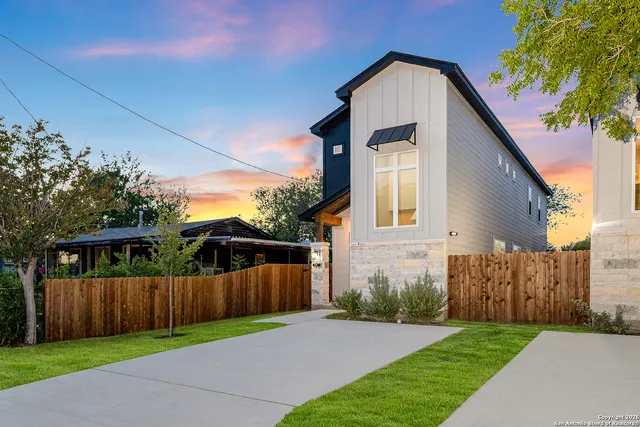 a view of backyard with small cabin and wooden fence