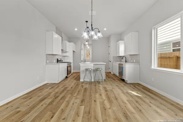 a open kitchen with cabinets a sink and stainless steel appliances
