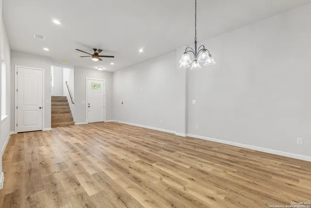 a view of a livingroom with a chandelier fan