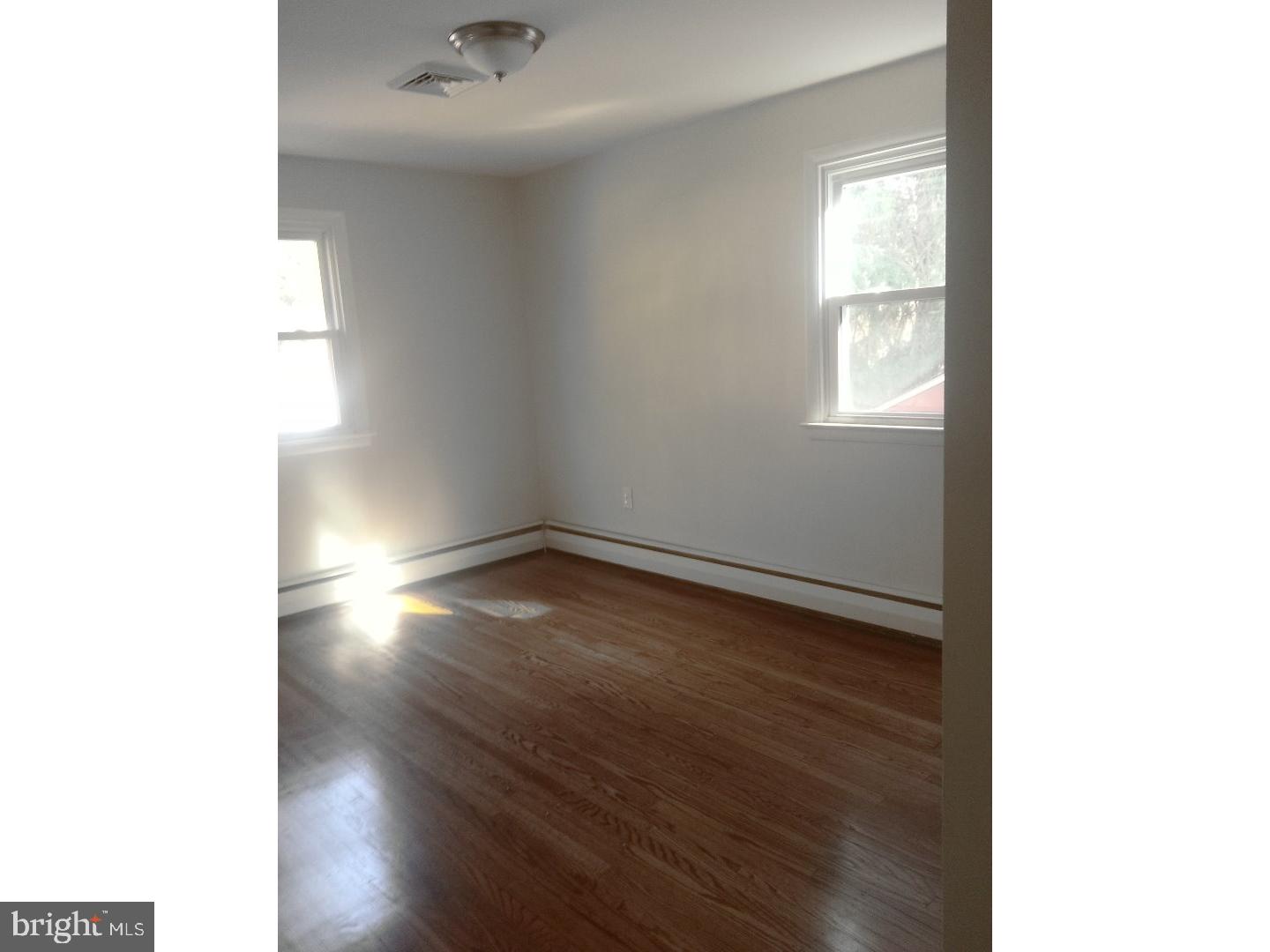 116 Bartholomew Road Berwyn, PA 19312 - Photo 13 of 24 a view of an empty room with wooden floor and a window