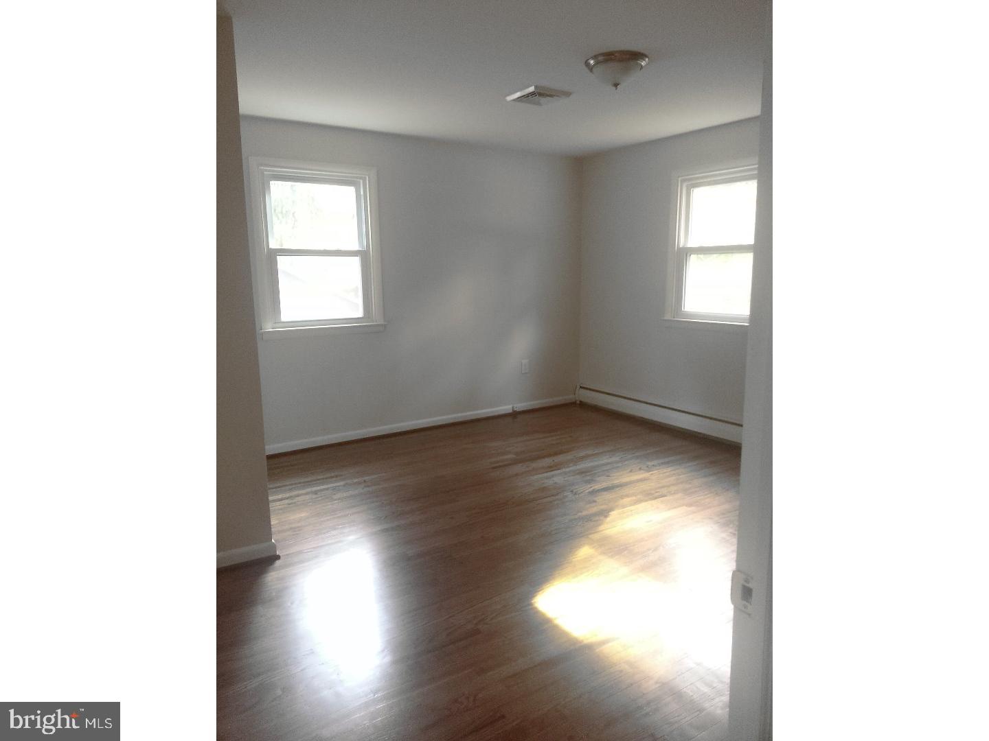 116 Bartholomew Road Berwyn, PA 19312 - Photo 14 of 24 a view of empty room with wooden floor and fan