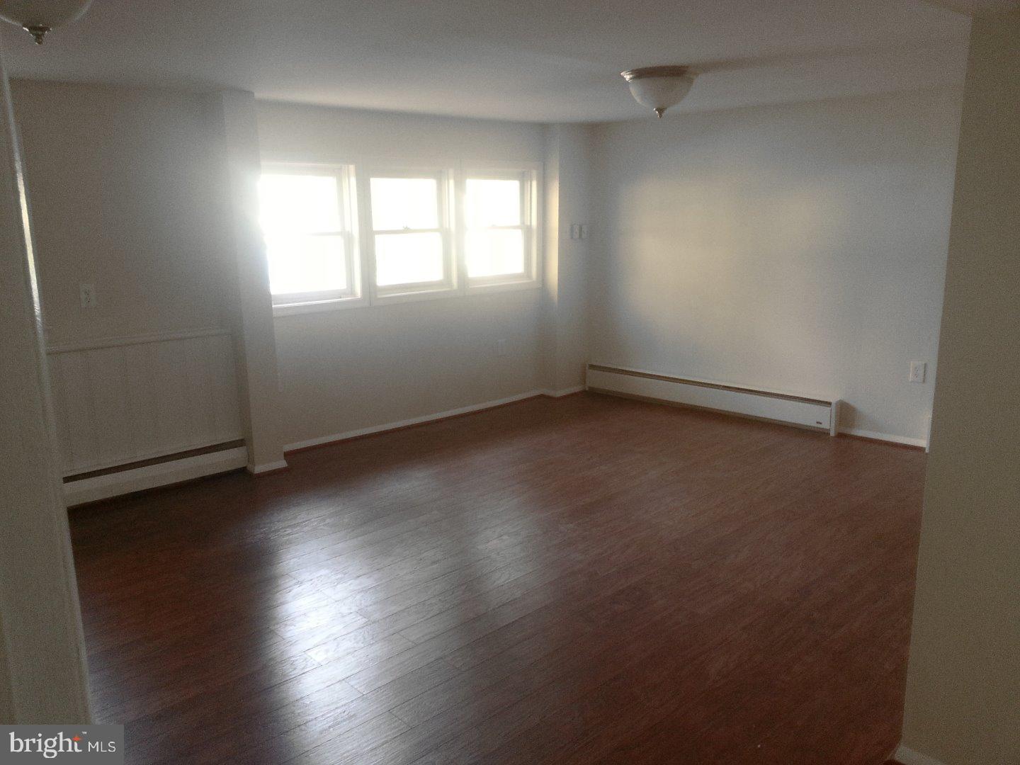 116 Bartholomew Road Berwyn, PA 19312 - Photo 15 of 24 an empty room with wooden floor and windows
