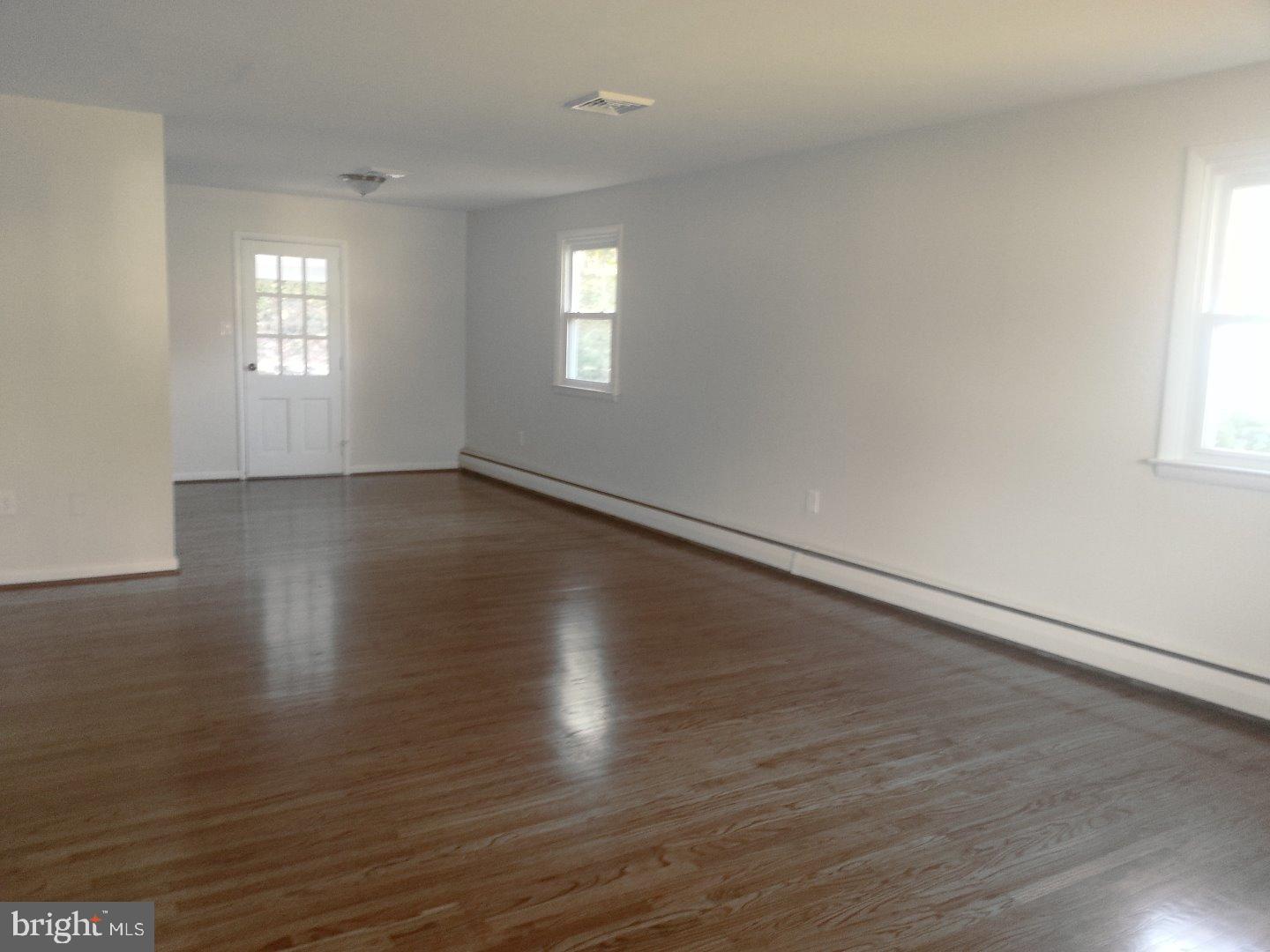116 Bartholomew Road Berwyn, PA 19312 - Photo 3 of 24 an empty room with wooden floor and windows