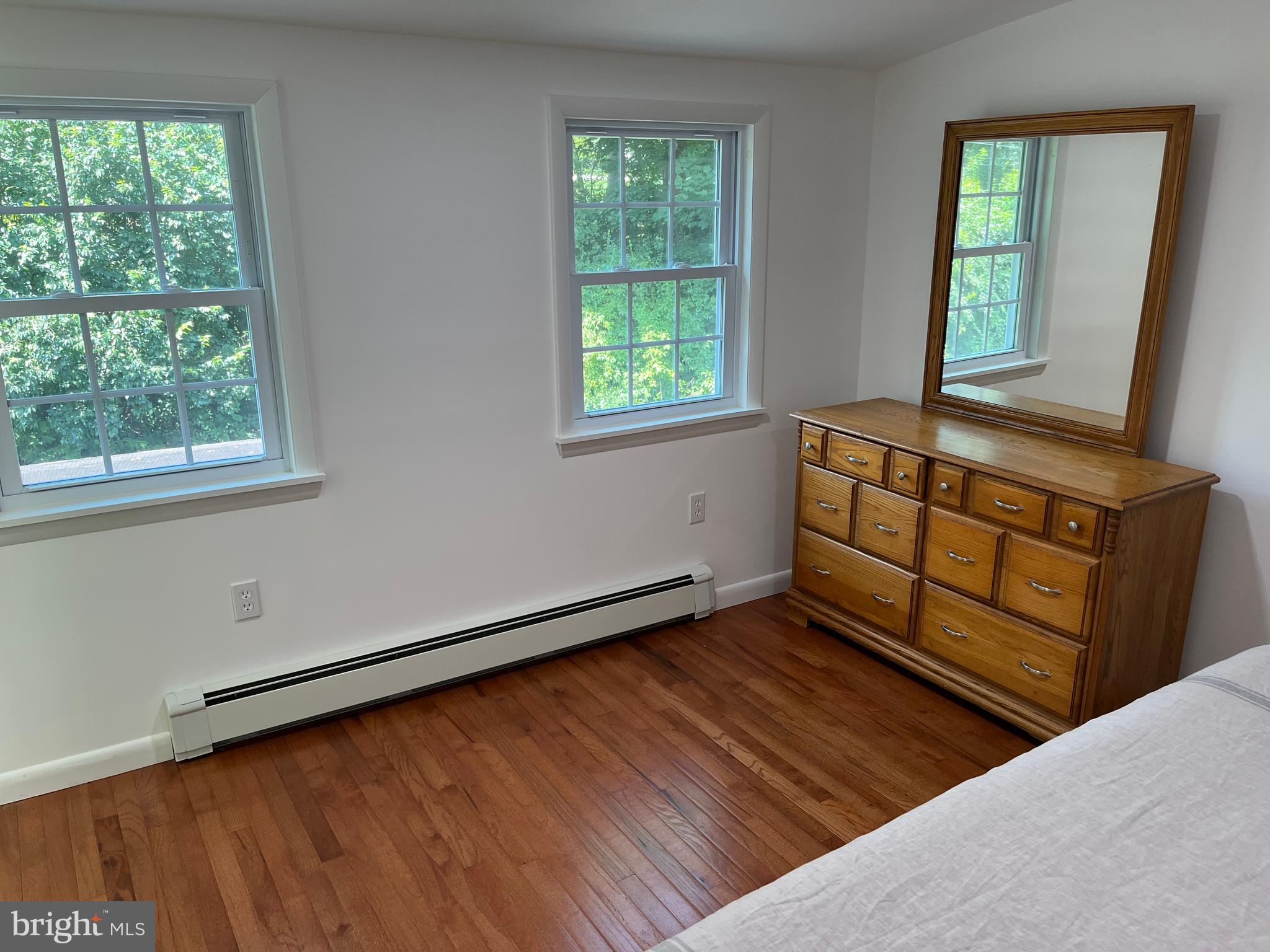 116 Bartholomew Road Berwyn, PA 19312 - Photo 7 of 24 a view of an empty room with wooden floor and a window