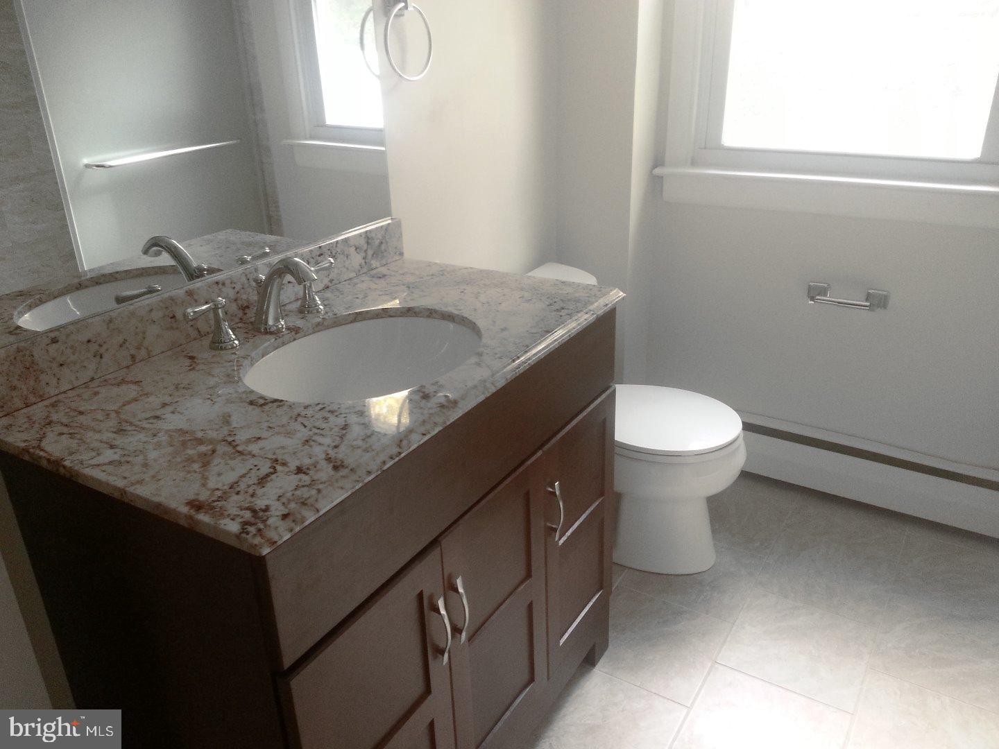 116 Bartholomew Road Berwyn, PA 19312 - Photo 8 of 24 a bathroom with a granite countertop sink and a toilet