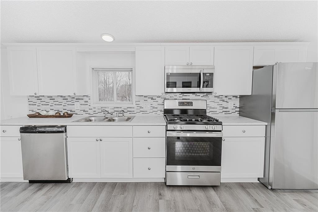 821 Windy Acres Road Saltsburg, PA 15681 - Photo 15 of 31 a kitchen with granite countertop white cabinets and stainless steel appliances