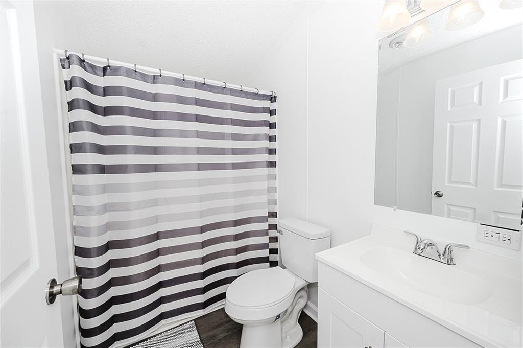 821 Windy Acres Road Saltsburg, PA 15681 - Photo 24 of 31 a bathroom with a sink a toilet and a mirror