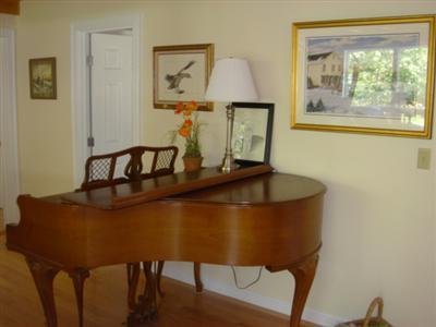 71 Upland Circle Brewster, MA 02631 - Photo 13 of 29 a view of a room that has a table and a chair in it