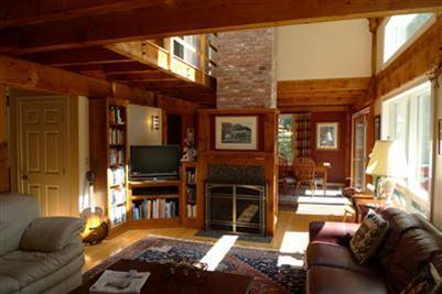 71 Upland Circle Brewster, MA 02631 - Photo 2 of 29 a living room with furniture a flat screen tv and floor to ceiling window