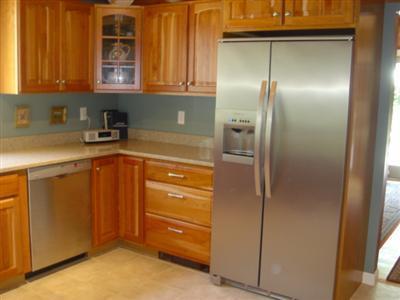 71 Upland Circle Brewster, MA 02631 - Photo 23 of 29 a kitchen with a refrigerator and cabinets