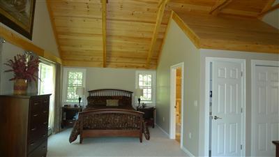 71 Upland Circle Brewster, MA 02631 - Photo 27 of 29 a bedroom with a bed and a table