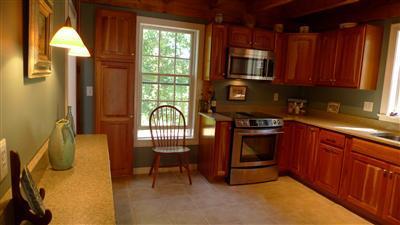 71 Upland Circle Brewster, MA 02631 - Photo 28 of 29 a kitchen with stainless steel appliances granite countertop a stove a sink and a microwave