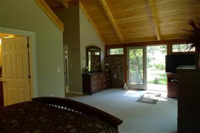 71 Upland Circle Brewster, MA 02631 - Photo 29 of 29 a bedroom with a bed closet and flat tv screen