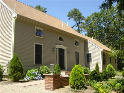 71 Upland Circle Brewster, MA 02631 - Photo 7 of 29 a front view of a house with garden