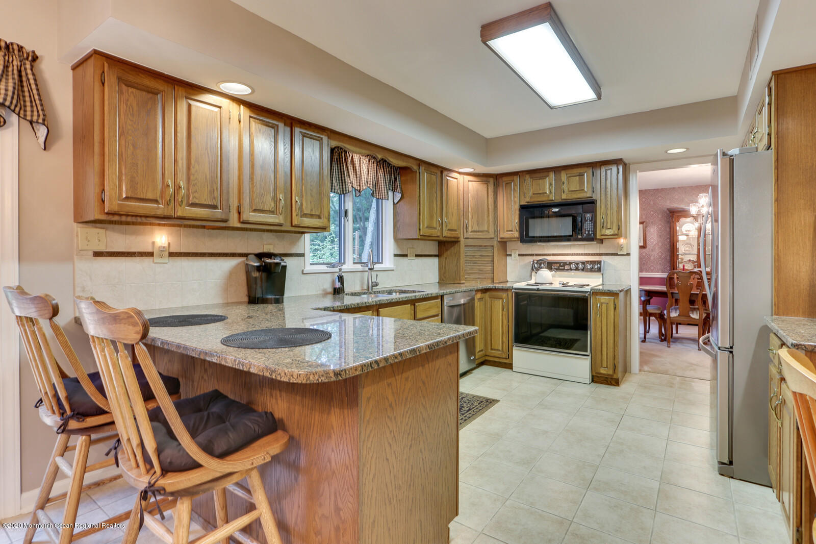 512 Province Line Road Allentown, NJ 08501 - Photo 13 of 38 a kitchen with kitchen island granite countertop a stove top oven a sink a dining table and chairs