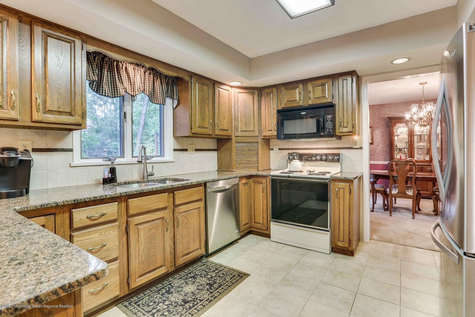 512 Province Line Road Allentown, NJ 08501 - Photo 9 of 38 a kitchen with stainless steel appliances granite countertop a stove sink and cabinets