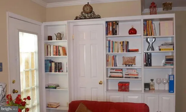 a living room with furniture and a book shelf