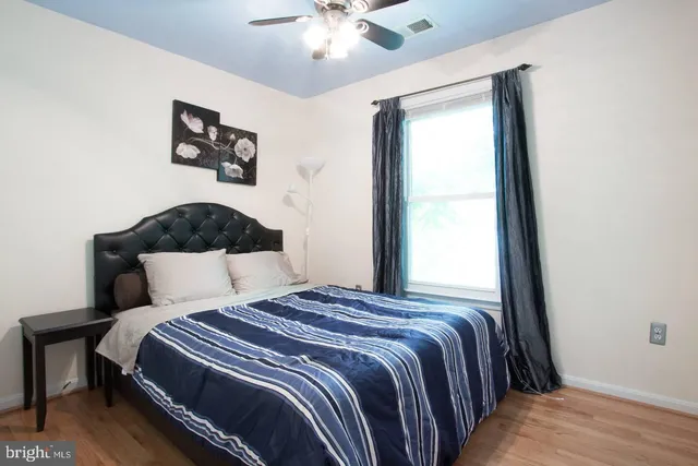 a bedroom with a large bed and a chandelier
