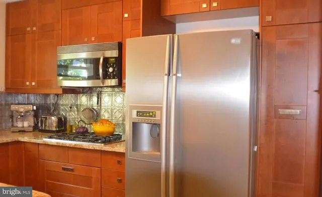 a kitchen with a refrigerator and a sink