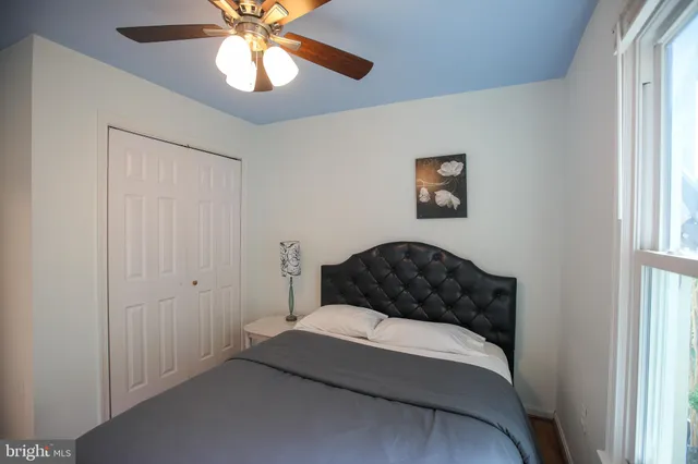 a bedroom with a bed and a window