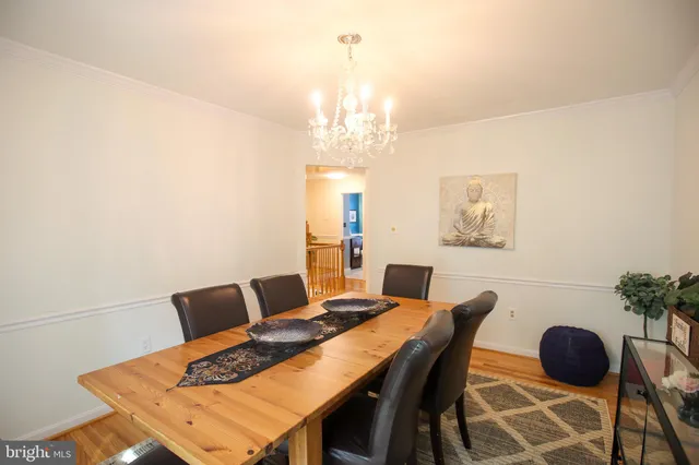 a view of a dining room with furniture and chandelier