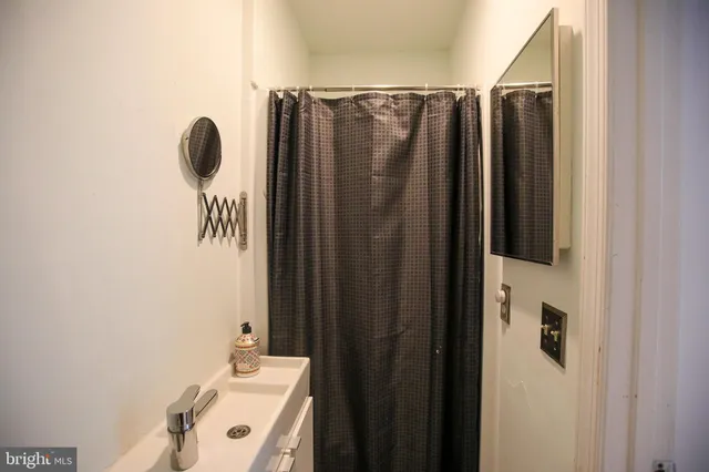 a bathroom with a shower and a sink