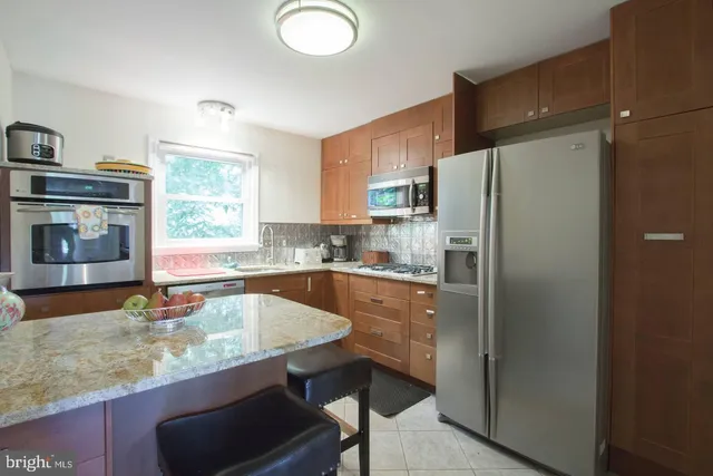 a kitchen with refrigerator cabinets and a sink
