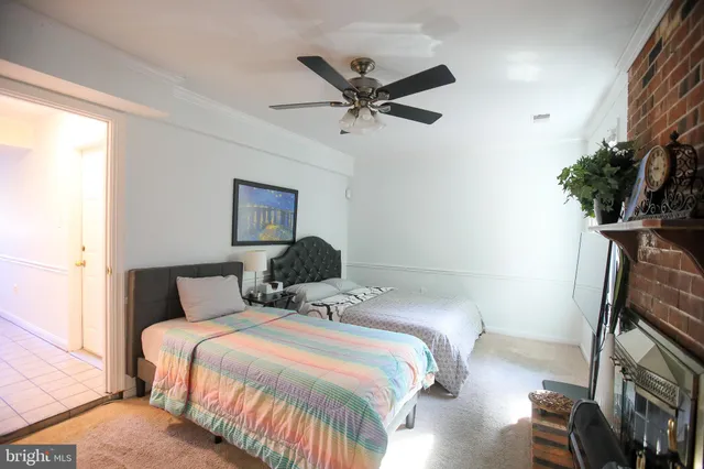 a bedroom with a bed and a potted plant