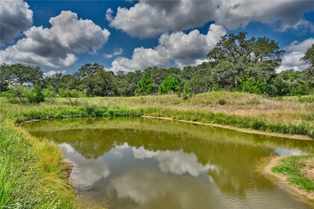 a view of a lake in between two of trees