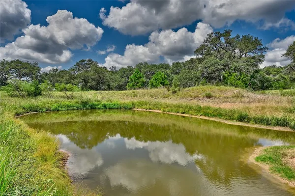 a view of a lake in between two of trees