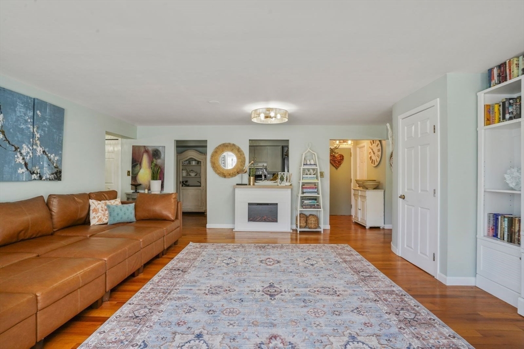 1 Commodore Court, Unit 104 Hull, MA 02045 - Photo 8 of 35 a living room with furniture and a fireplace