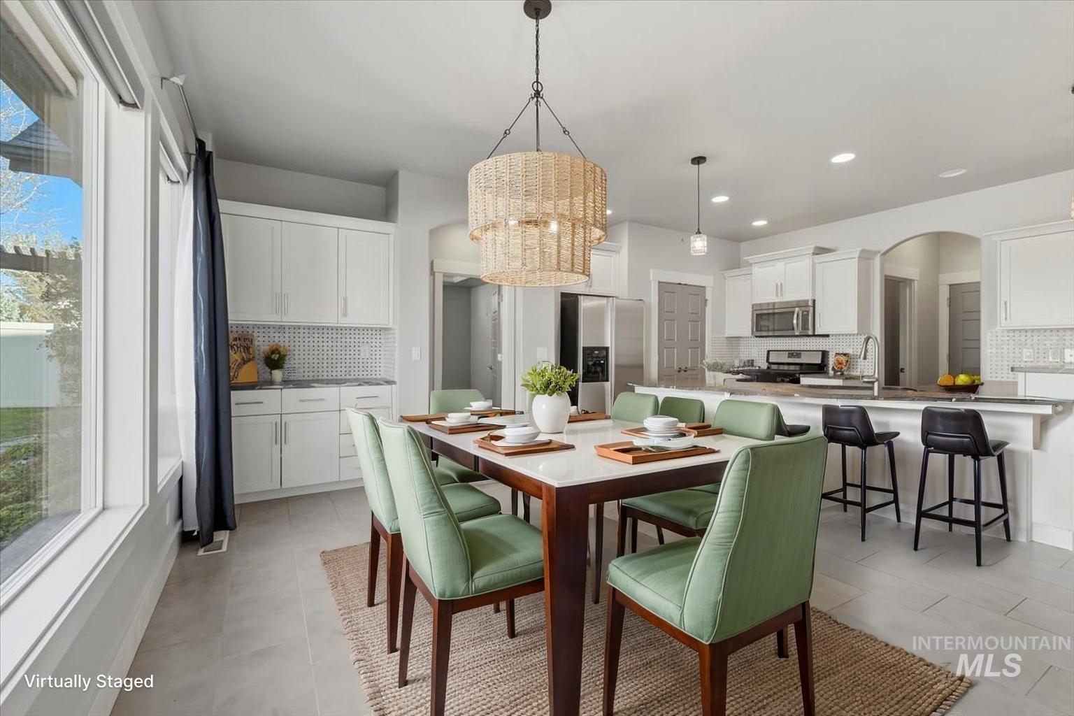 15381 Silver Oak Way Caldwell, ID 83607 - Photo 11 of 48 Dining area with arched walkways and hanging lights