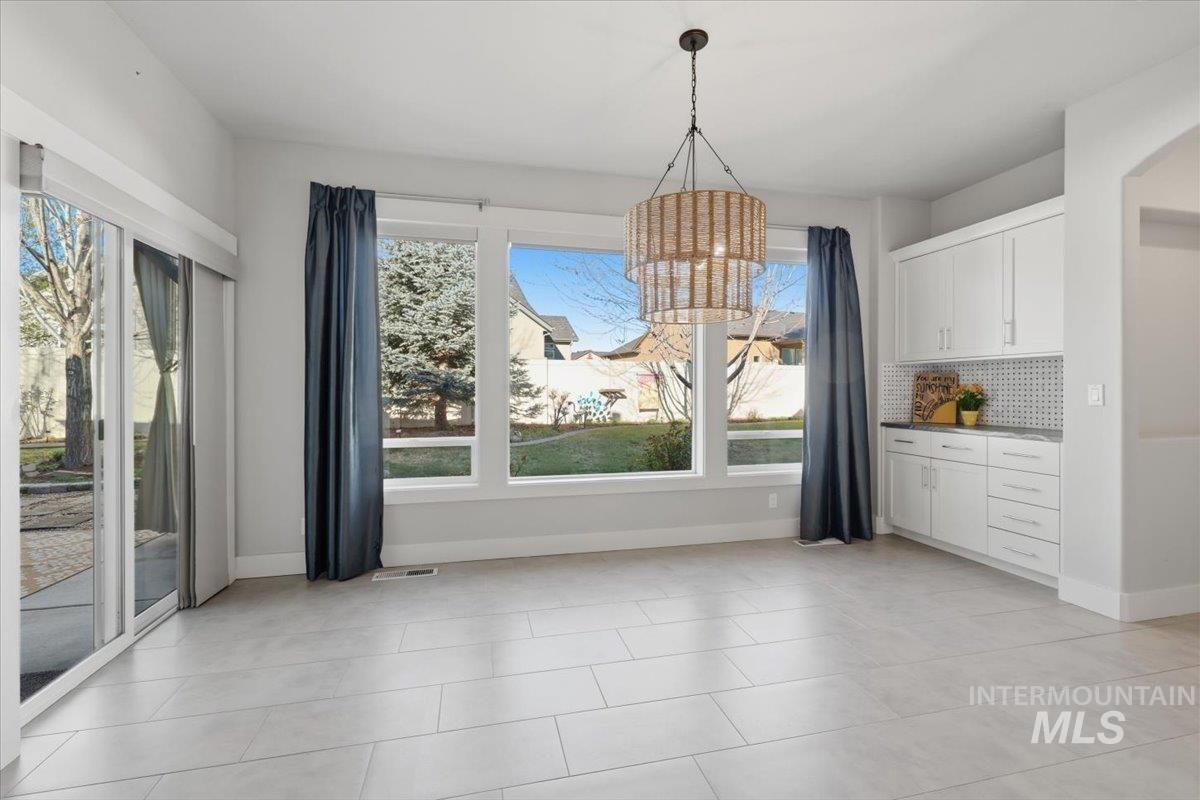 15381 Silver Oak Way Caldwell, ID 83607 - Photo 14 of 48 Unfurnished dining area with suspended lighting and light tile patterned floors