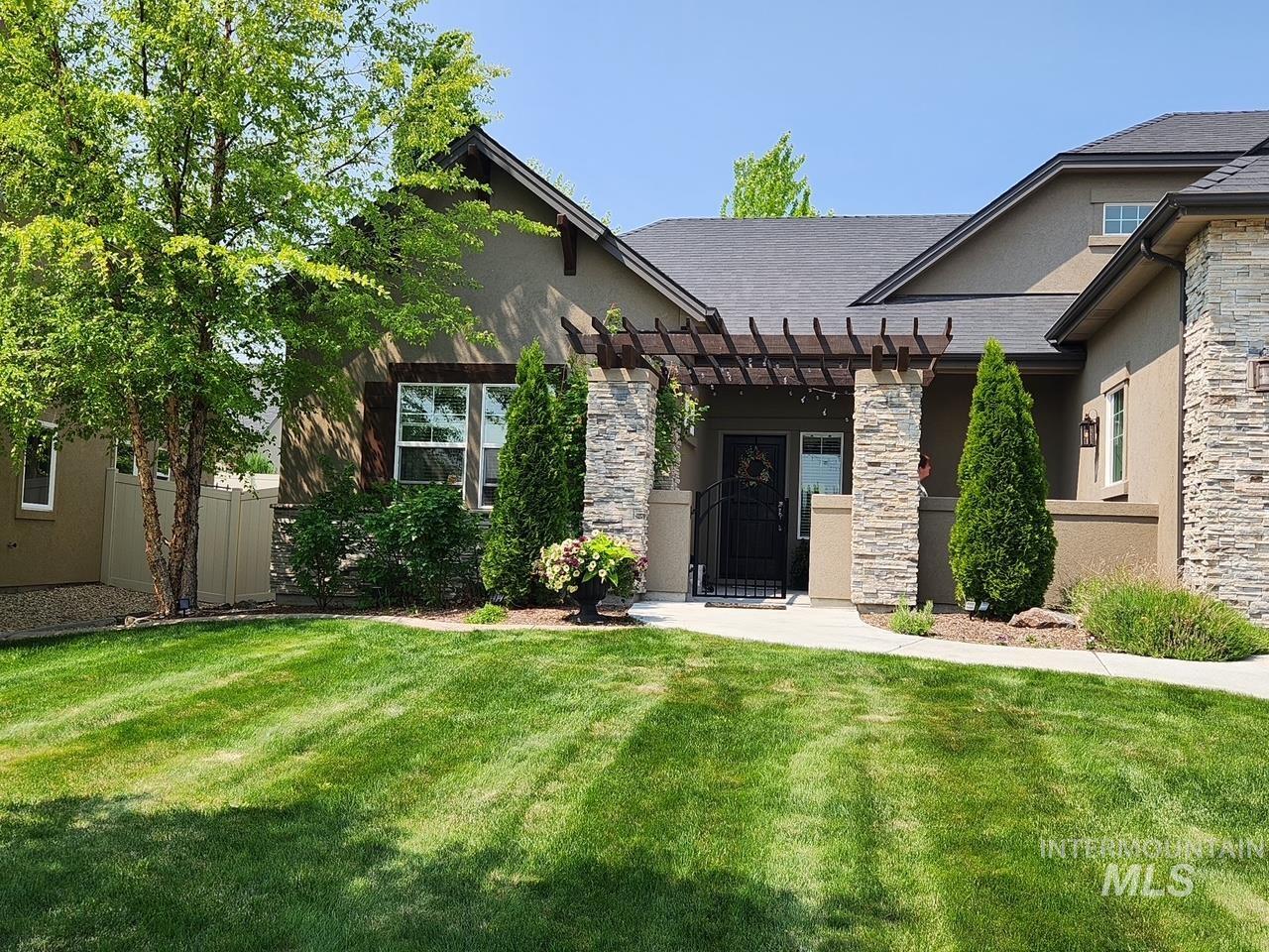 15381 Silver Oak Way Caldwell, ID 83607 - Photo 2 of 48 View of front of property featuring a pergola, a patio, stucco siding, stone siding, and a shingled roof