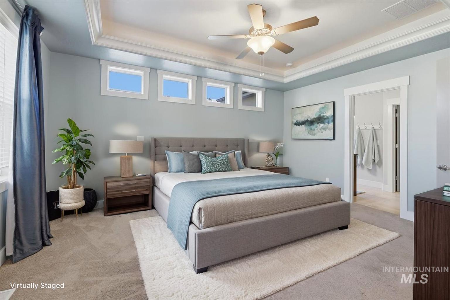 15381 Silver Oak Way Caldwell, ID 83607 - Photo 24 of 48 Bedroom with a raised ceiling, light carpet, a ceiling fan, and connected bathroom
