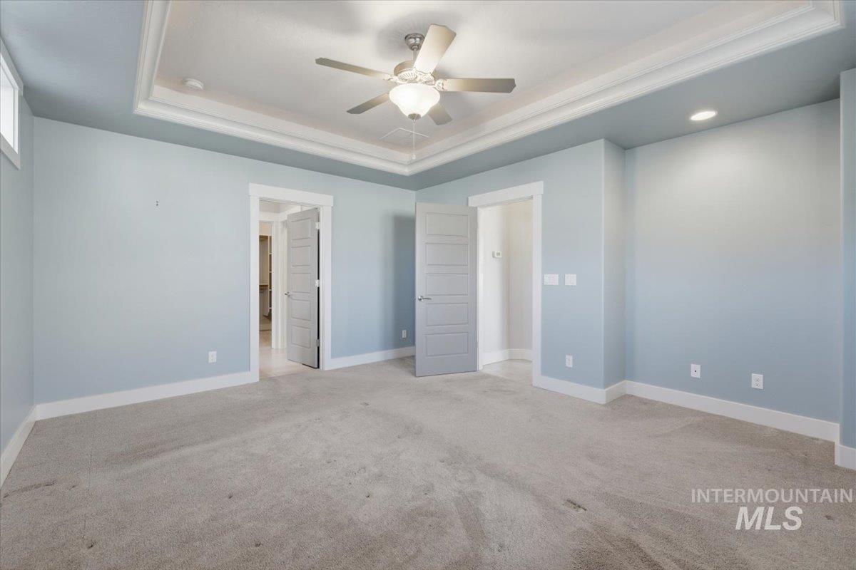15381 Silver Oak Way Caldwell, ID 83607 - Photo 25 of 48 Unfurnished bedroom with a raised ceiling, light colored carpet, ceiling fan, and recessed lighting