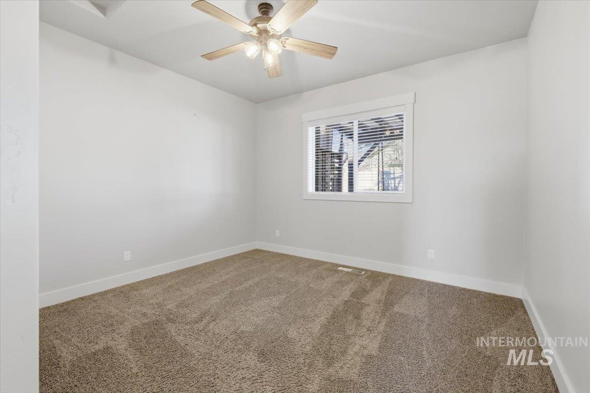 15381 Silver Oak Way Caldwell, ID 83607 - Photo 30 of 48 Unfurnished room with carpet and a ceiling fan