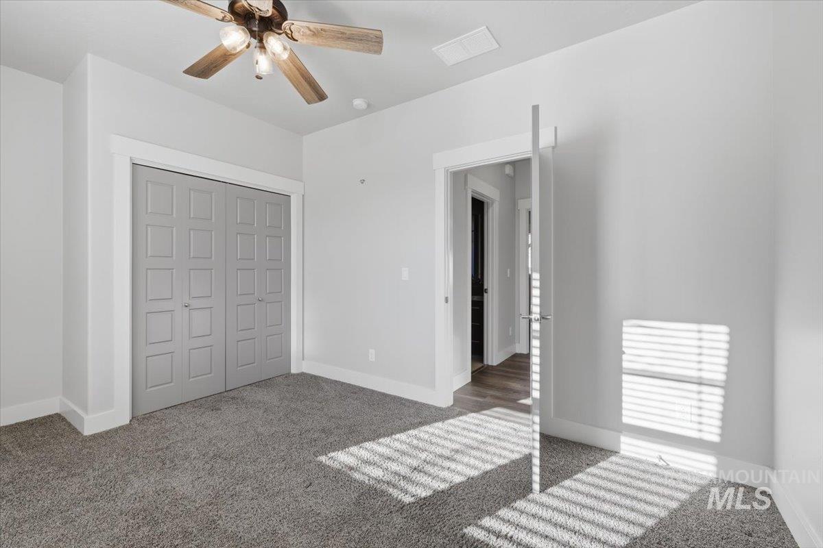 15381 Silver Oak Way Caldwell, ID 83607 - Photo 32 of 48 Unfurnished bedroom with carpet floors, a closet, and a ceiling fan