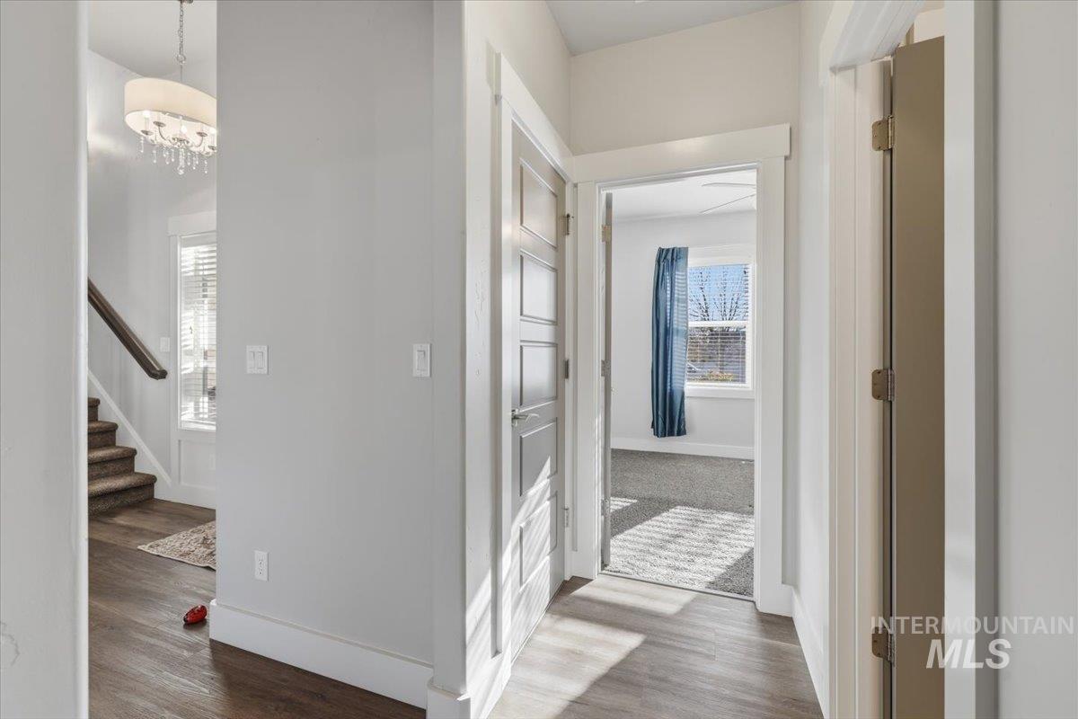 15381 Silver Oak Way Caldwell, ID 83607 - Photo 33 of 48 Hallway with wood finished floors and suspended lighting