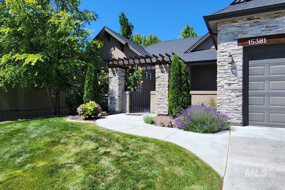 15381 Silver Oak Way Caldwell, ID 83607 - Photo 45 of 48 Entrance to property with stone siding, a gate, and a pergola