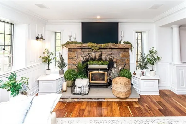 a living room with furniture a flat screen tv and a fireplace