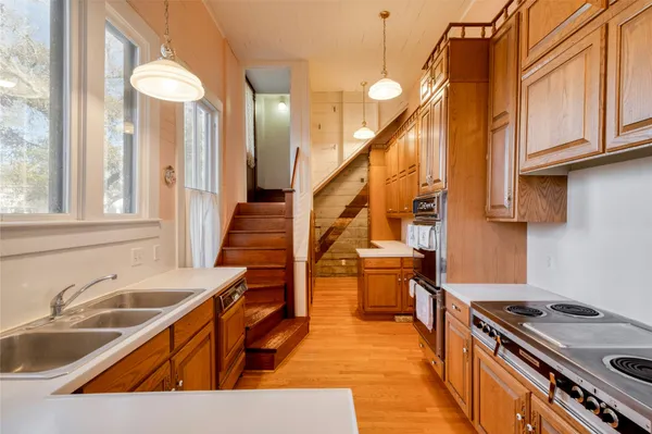 a kitchen with stainless steel appliances granite countertop a stove and a microwave