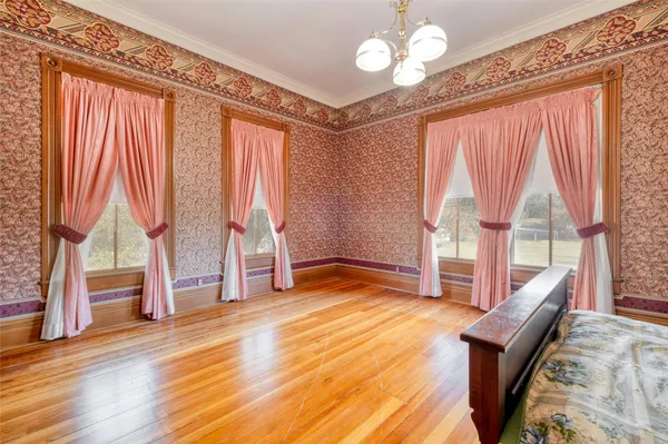 a living room with wooden floor and furniture