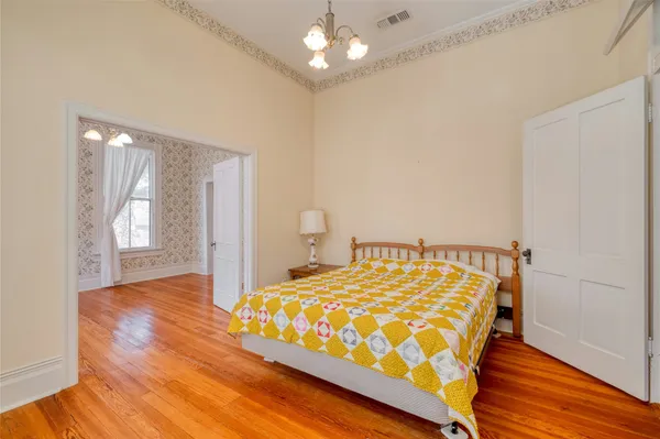 a bedroom with a bed and a window