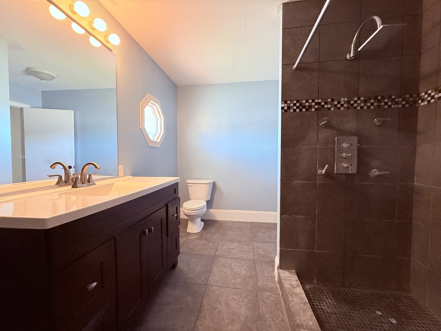 402 North Madison Street Clinton, IL 61727 - Photo 12 of 24 a bathroom with a sink a toilet and shower