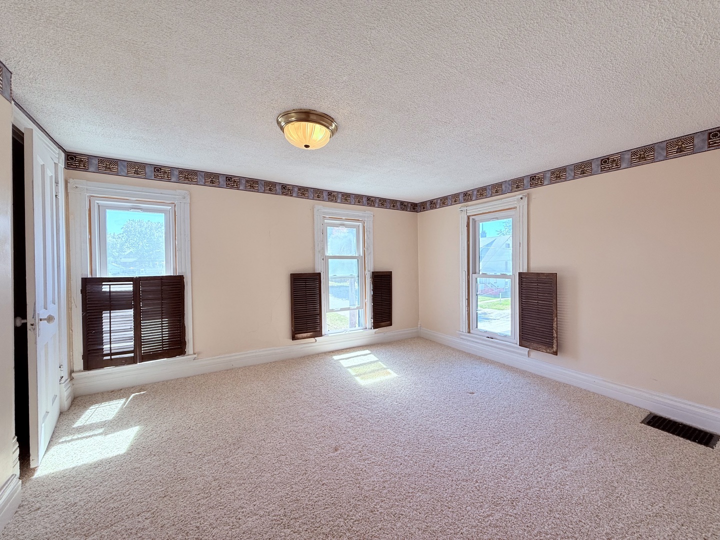 402 North Madison Street Clinton, IL 61727 - Photo 19 of 24 a view of an empty room with a window and fireplace