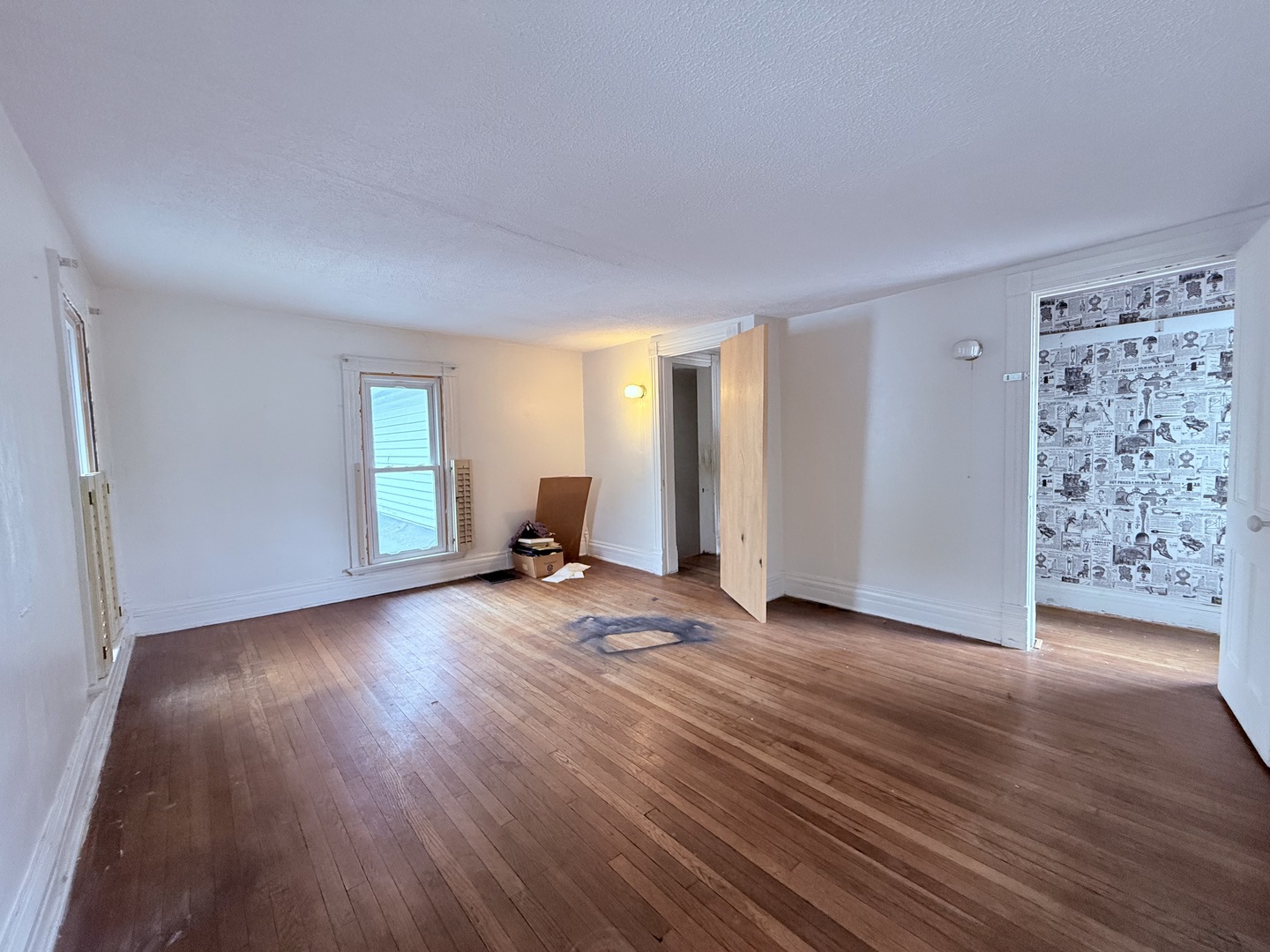 402 North Madison Street Clinton, IL 61727 - Photo 21 of 24 an empty room with wooden floor and windows