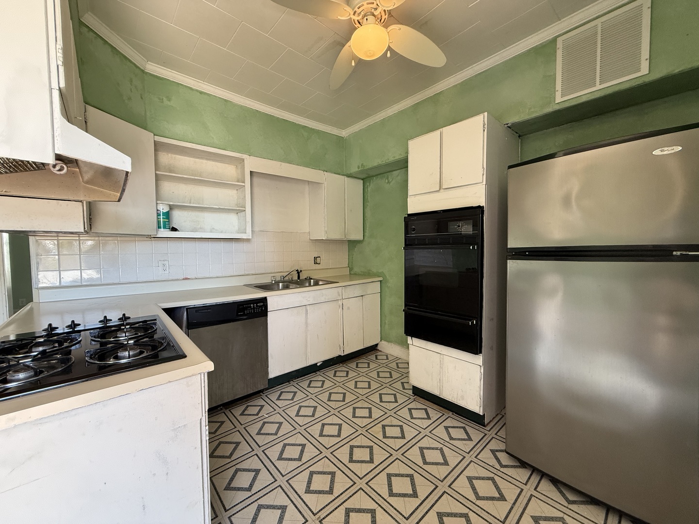 402 North Madison Street Clinton, IL 61727 - Photo 4 of 24 a kitchen with stainless steel appliances a refrigerator a sink a stove and white cabinets