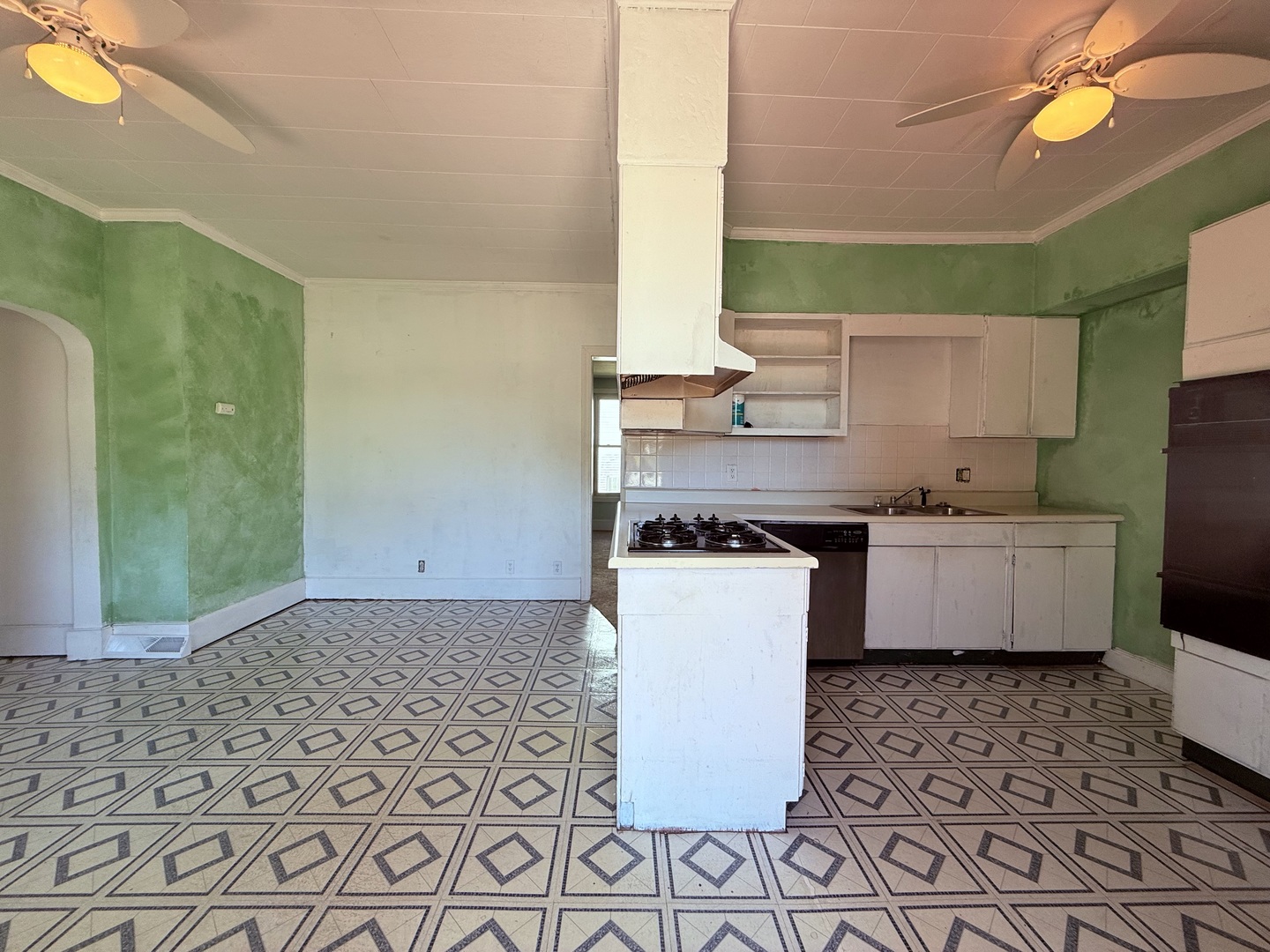 402 North Madison Street Clinton, IL 61727 - Photo 5 of 24 a kitchen with a sink a stove cabinets and a dining table